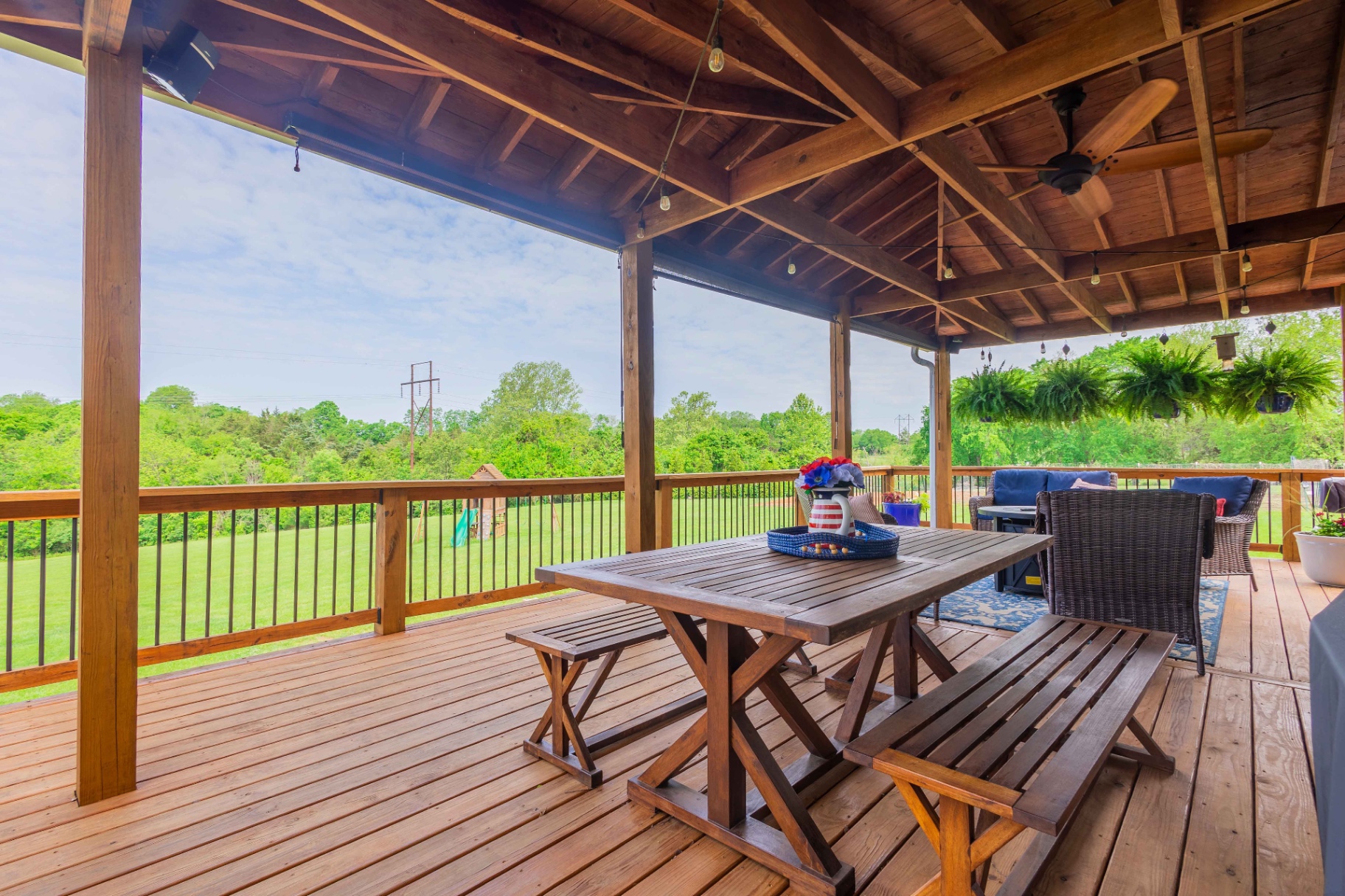 Covered deck with farmhouse dining table — Central Kentucky